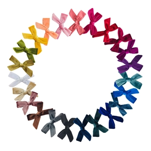 24 colors of velvet bow hair clips arranged in a circle with premium matte textures