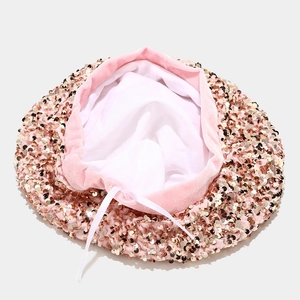 Detailed view of pink sequin beret with velvet trim and adjustable inner drawstring