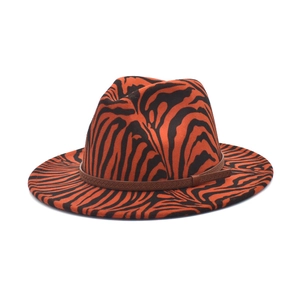 Detail of the orange and black tiger print fedora with a brown braided buckle band