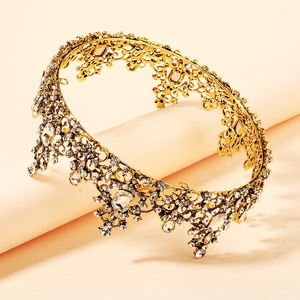 Golden Baroque crown with sparkling crystals shown in a 45-degree angle studio view