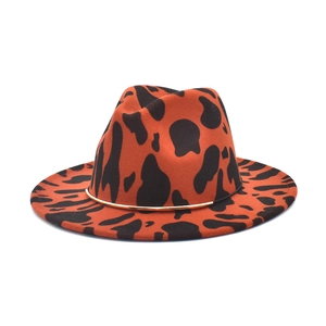 Detail of orange cow print fedora hat with gold metal band on premium wool felt material