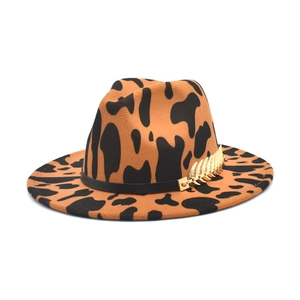 Close-up of leopard print wool fedora hat with black band and gold leaf chain accessory