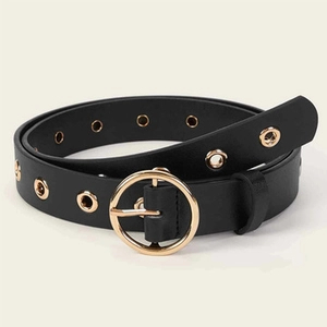 Detail view of black faux leather belt featuring a golden round buckle and metal eyelets