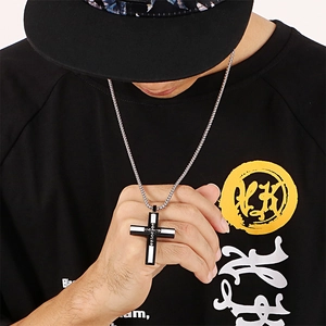 Men's silver and black cross pendant necklace with stainless steel chain on model
