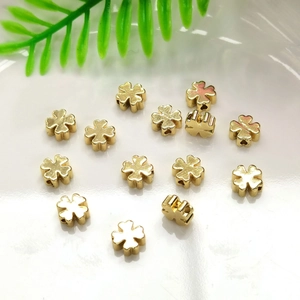 Clover shaped 14K gold filled spacer beads for DIY jewelry making accessories on ceramic