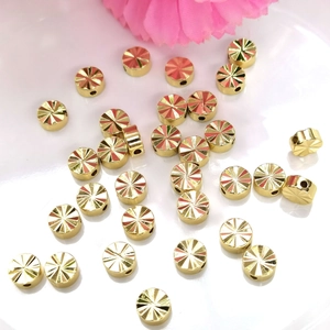 Detailed view of 14K gold filled spacer beads with faceted radial cut for DIY jewelry