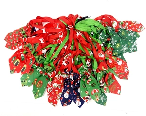 Pile of festive Christmas pet ties with snowmen and santa patterns for cats and dogs