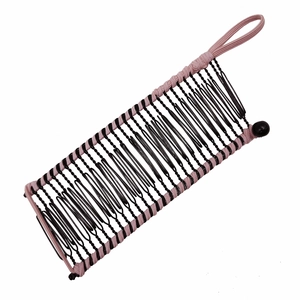 Detailed view of a pink fabric woven banana hair clip with secure black metal teeth