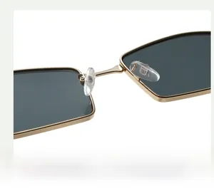 Close-up of adjustable silicone nose pads on gold metal sunglasses frame
