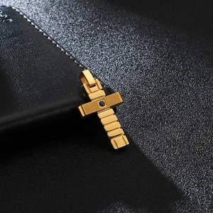 Elegant gold cross pendant with black zircon stone on a premium black leather background