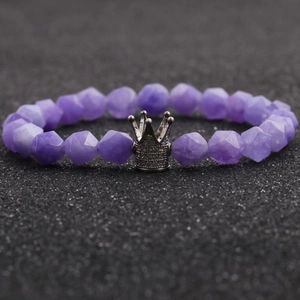Purple faceted agate bead bracelet with a silver pave crown charm on a black display