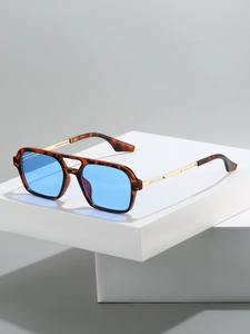 Detail view of aviator square sunglasses with tortoise shell frames and light blue lenses