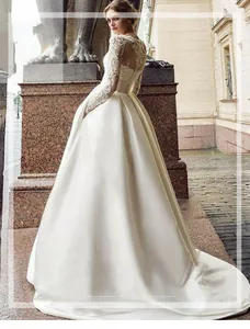 Exquisite lace details on ivory satin wedding dress sleeve with floral embroidery