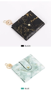 Close-up of marble pattern card holders with gold keychains and snap buttons