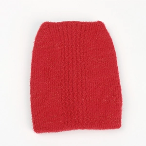 Detail of red knit hat featuring fluffy faux mink fur and subtle golden metallic threads