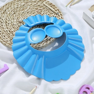 Blue adjustable baby shower cap for hair washing with ear protection on white cloth