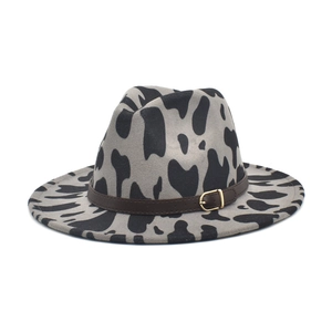 Fedoras wool felt hat featuring black cow print patterns and leather belt with gold buckle
