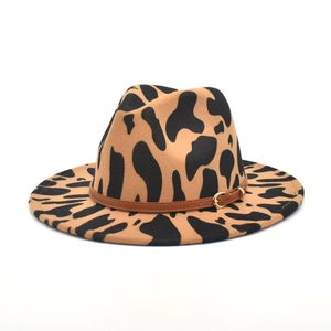 Close-up of leopard print felt hat texture with brown leather buckle strap detail