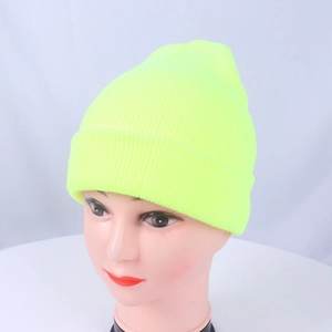 Detail of neon yellow ribbed knit beanie showing textured weave and fold-over cuff style