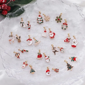 Festive Christmas earring set with Santa, reindeer and tree designs on crystal background