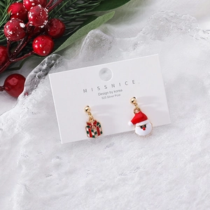 Detail of Christmas earrings featuring Santa and bow gift box on 925 silver posts