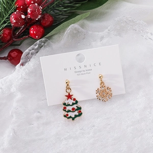 Detailed view of asymmetric Christmas tree and snowflake earrings with sparkling rhinestones