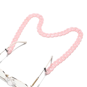 Detail of pink acrylic glasses chain with chunky links attached to gold frame