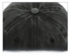 Top view detail of durable stitched crown and button on washed denim baseball cap