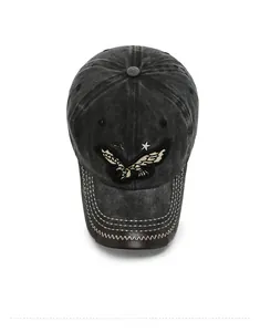 Detailed close-up of eagle embroidery and leather brim trim on vintage denim cap