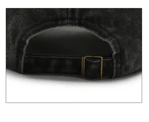 Detail of adjustable metal buckle and washed denim texture on vintage baseball cap