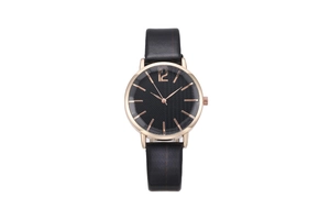 Detail of rose gold case with black textured dial and minimalist leather watch strap