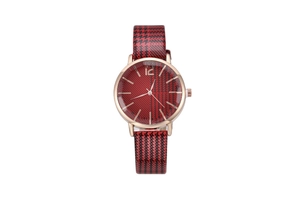 Macro view showing the red and black houndstooth pattern dial and rose gold watch case