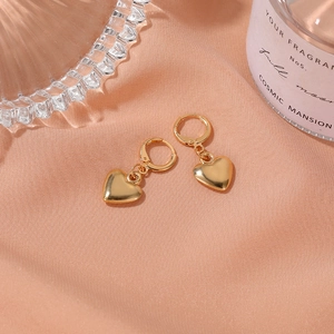 Boucles d'oreilles cœur dorées minimalistes avec finition miroir sur soie rose