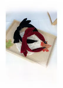 Detail of velvet bow headbands in black and wine red colors on a seasonal display