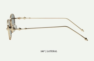 Side view of golden metal sunglasses with geometric diamond temple details and dark lenses
