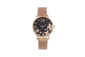 Detailed macro of rose gold floral dial and black face with mesh metal strap