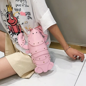 Close-up of pink lobster crossbody bag with gold stud details and elegant chain strap
