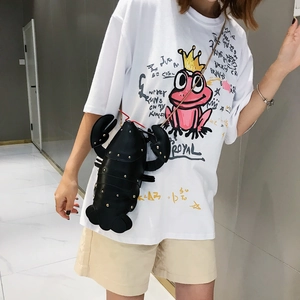 Fashionable black lobster shaped crossbody bag with metallic studs shown on a model