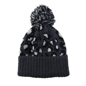 Detail of leopard print knit beanie with large faux fur pompom and ribbed cuff
