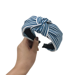Blue and white striped denim fabric headband with a stylish top knot design for women