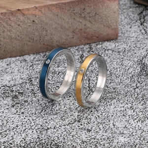 Brushed stainless steel couple rings with single zircon inlay in blue and gold finish