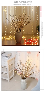 Detail of warm white LED willow branch lights in a white vase for Nordic home decor