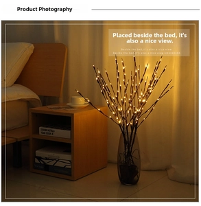 Close-up of decorative warm LED willow branch lights arranged in a gray glass vase