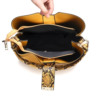 Fashionable snake skin pattern tote bag with yellow interior lining and multi-pocket design
