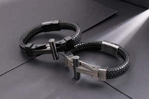 Detail of woven leather straps and stainless steel magnetic clasps on men's bracelets