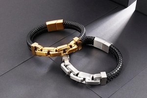 Macro detail of men's braided leather bracelet with stainless steel links and magnetic clasp