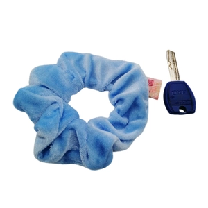Light blue velvet scrunchie with hidden pocket zipper and blue key on white background