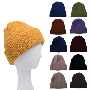 Detail view of double-layer knit beanies in multiple colors and ribbed texture