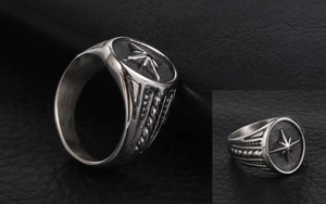 Macro detail of retro stainless steel men's ring with star pattern and side texture