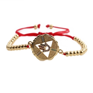 Red braided rope bracelet with gold star charm and colorful cubic zirconia inlay